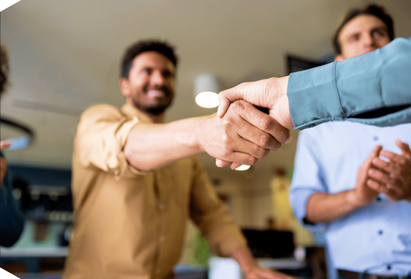 Handshake between two men in office.