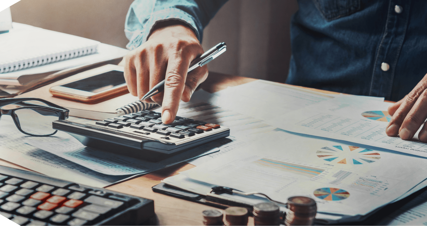 Person using calculator on financial documents.